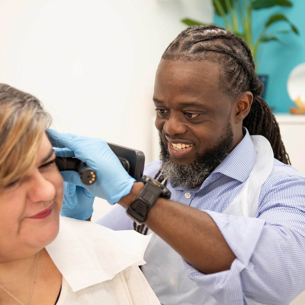 Sam removing ear wax from clients ear